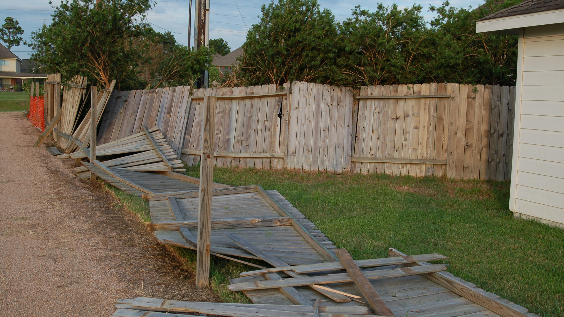 collapsed and damaged wooden fence
