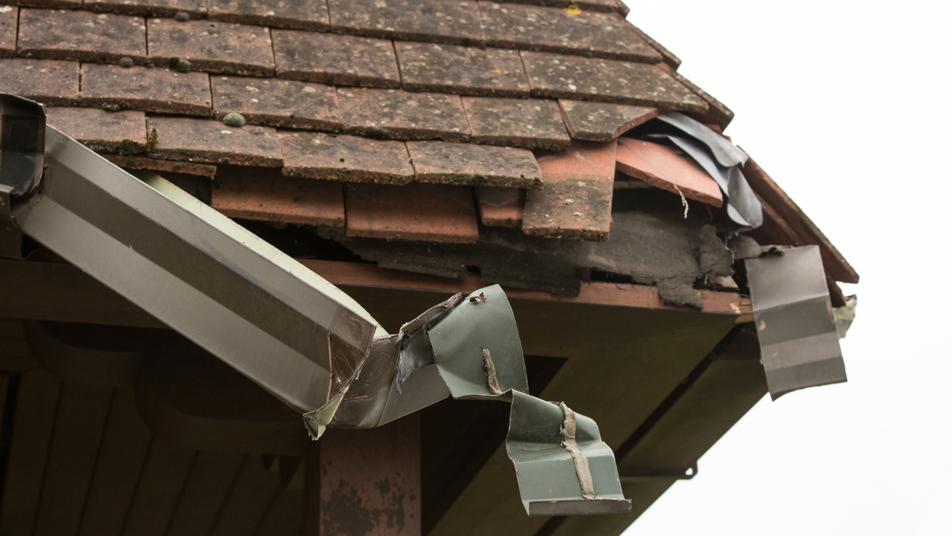 damaged roof tiles and gutter